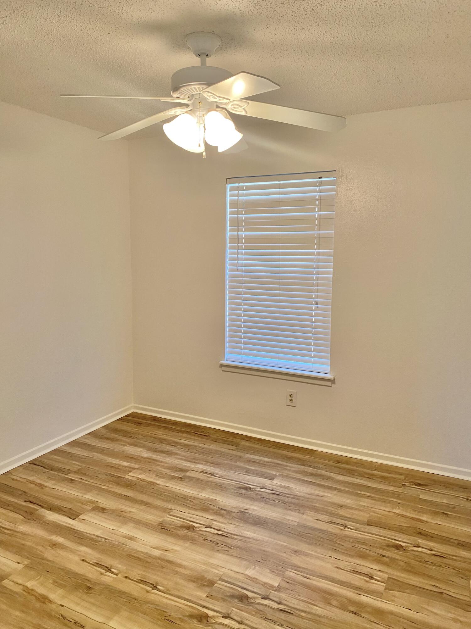 2128 74th Street Lubbock, TX 79423 - Photo 12 of 15 a view of a room with wooden floor and fan