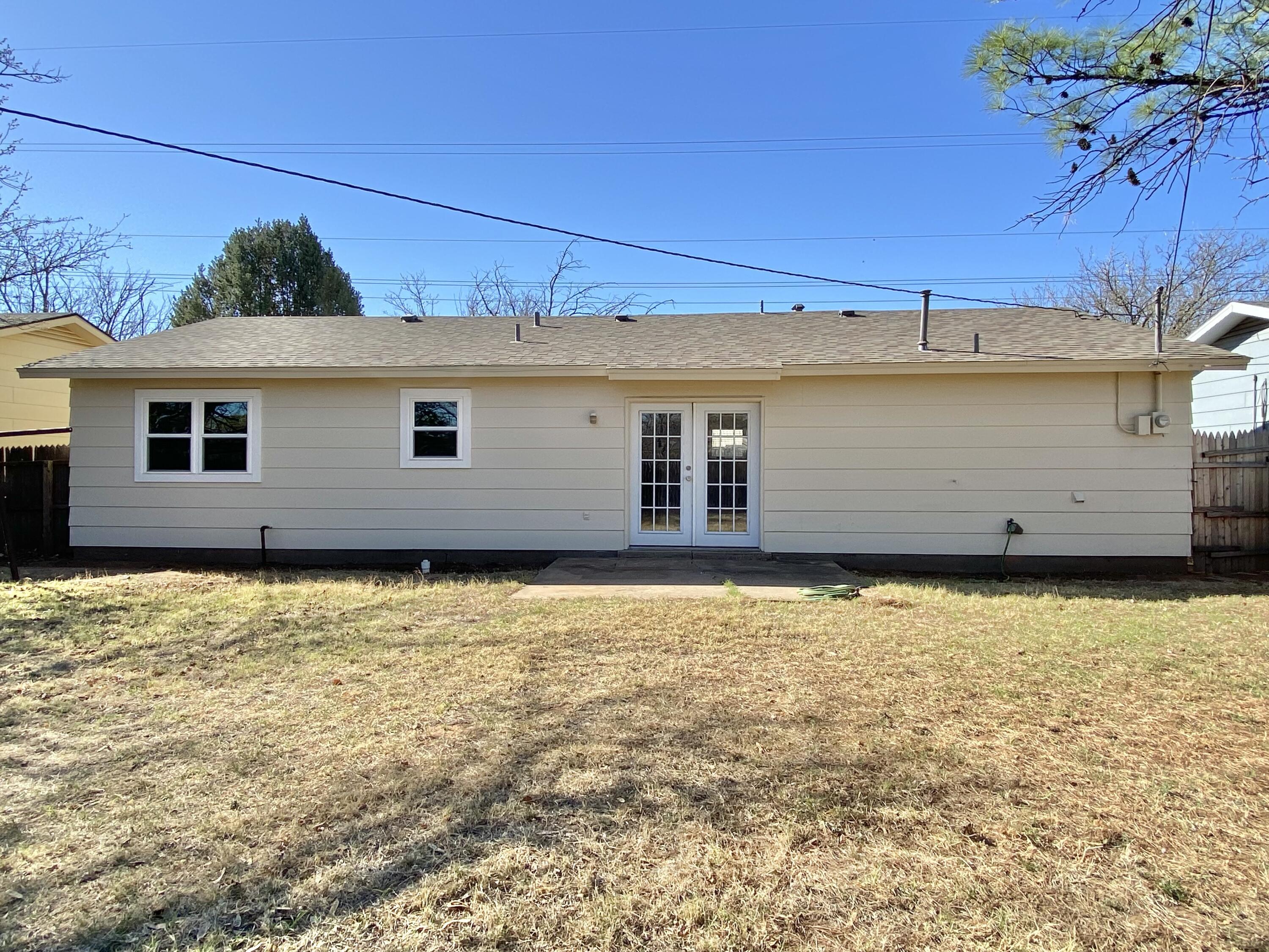 2128 74th Street Lubbock, TX 79423 - Photo 14 of 15 front view of a house with a yard