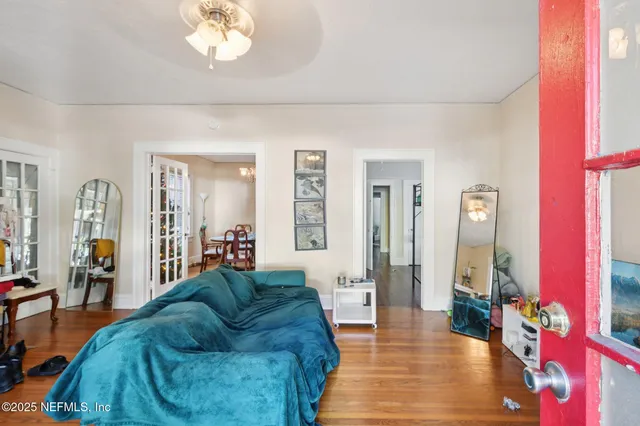 a living room with furniture and a chandelier