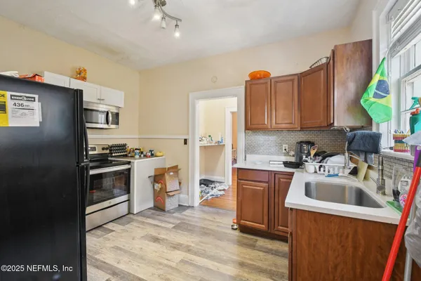 a kitchen with a refrigerator stove and sink