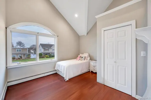 a bedroom with a bed and a large window