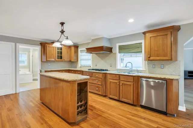 a kitchen with stainless steel appliances granite countertop wooden floors and granite counter tops