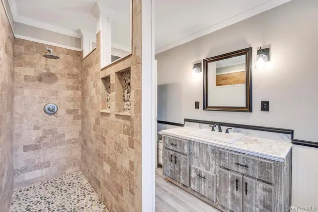 a bathroom with a double vanity sink a mirror and shower