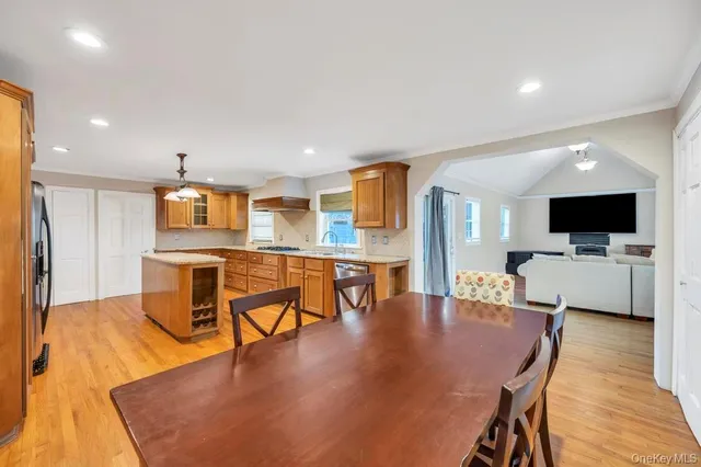an open kitchen with dining table and stainless steel appliances