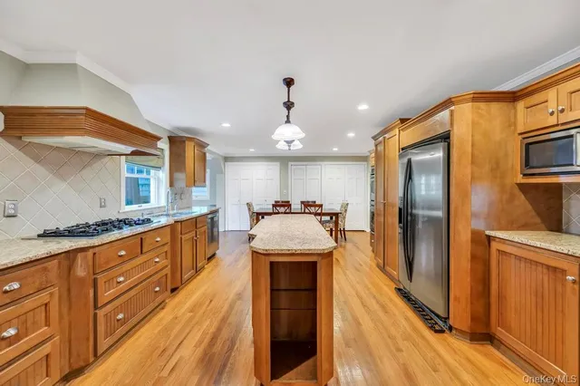 a large kitchen with stainless steel appliances granite countertop a large island in the center