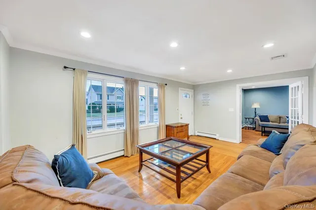 a living room with furniture a rug and a large window