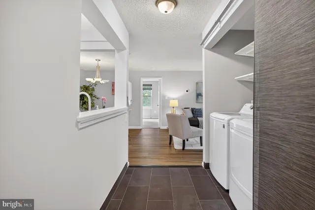 a view of a living room with furniture and a entryway