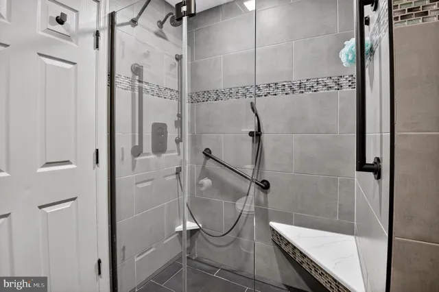 a bathroom with a glass shower door