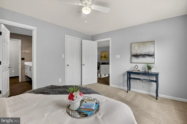 a living room with furniture and a dining table