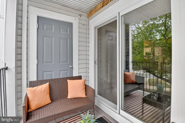 a view of a chairs and table in the balcony