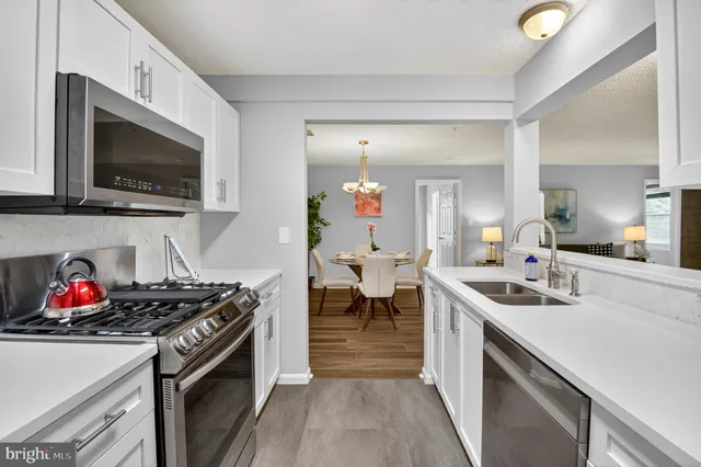a kitchen with a sink stove and cabinets