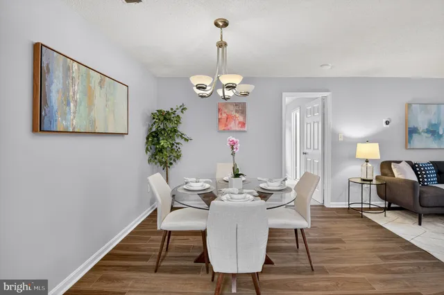 a view of a dining room with furniture wooden floor and chandelier