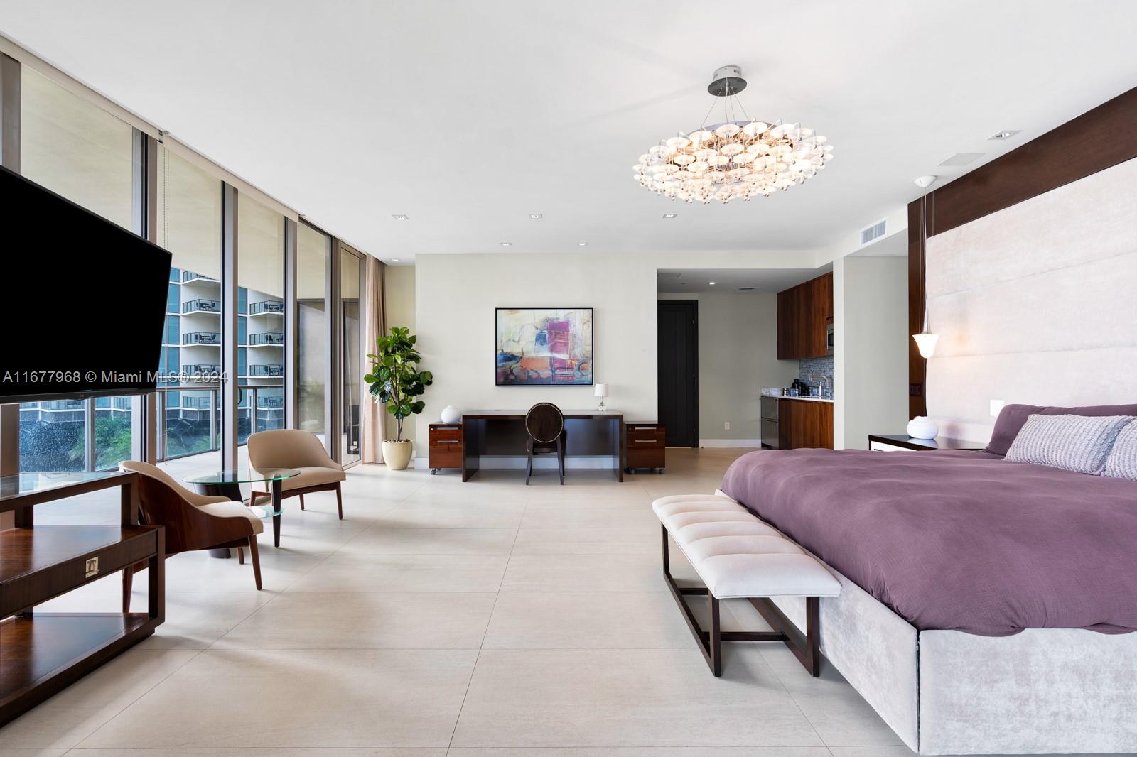 9705 Collins Avenue, Unit 501N Bal Harbour, FL 33154 - Photo 11 of 30 a living room with furniture a flat screen tv and a large window