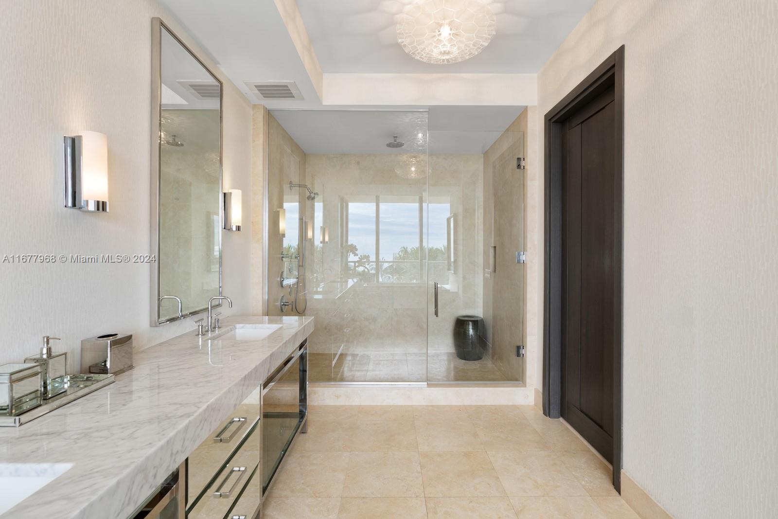 9705 Collins Avenue, Unit 501N Bal Harbour, FL 33154 - Photo 14 of 30 a bathroom with a granite countertop sink mirror and shower