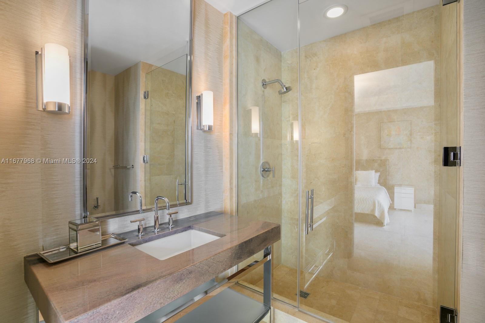 9705 Collins Avenue, Unit 501N Bal Harbour, FL 33154 - Photo 17 of 30 a bathroom with a granite countertop shower sink and mirror
