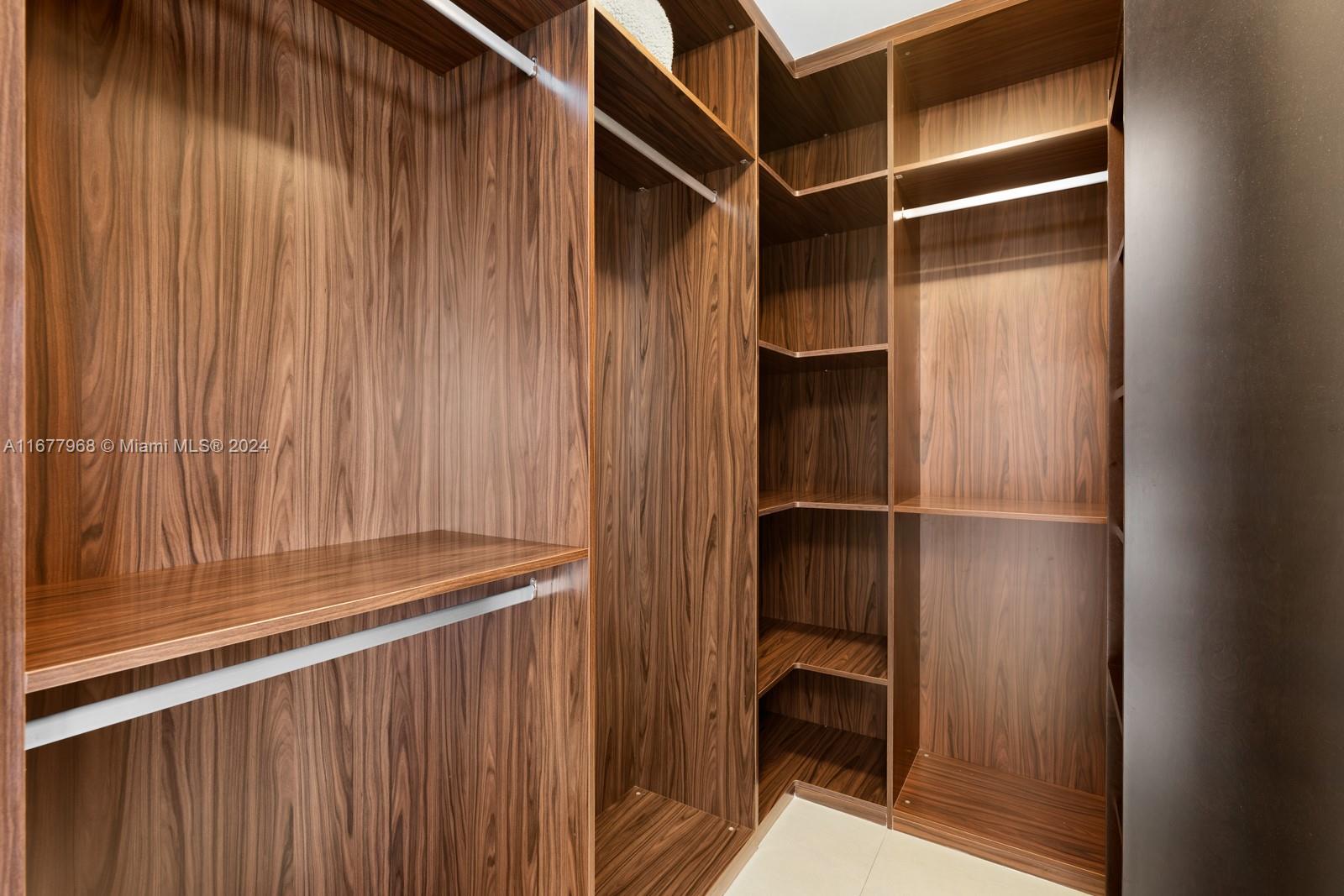 9705 Collins Avenue, Unit 501N Bal Harbour, FL 33154 - Photo 18 of 30 a view of walk in closet with clothes