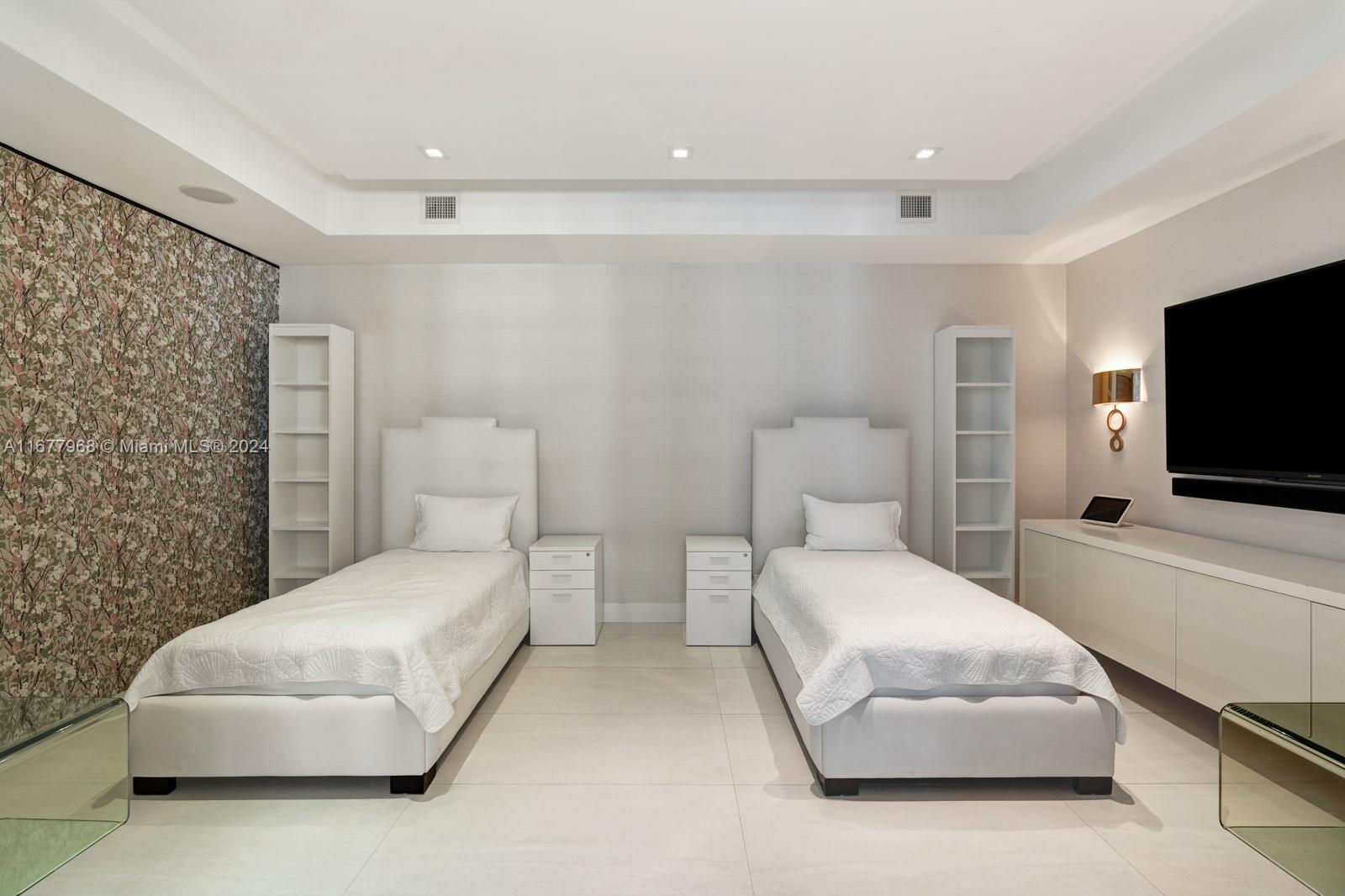 9705 Collins Avenue, Unit 501N Bal Harbour, FL 33154 - Photo 23 of 30 a bedroom with a bed and a flat screen tv