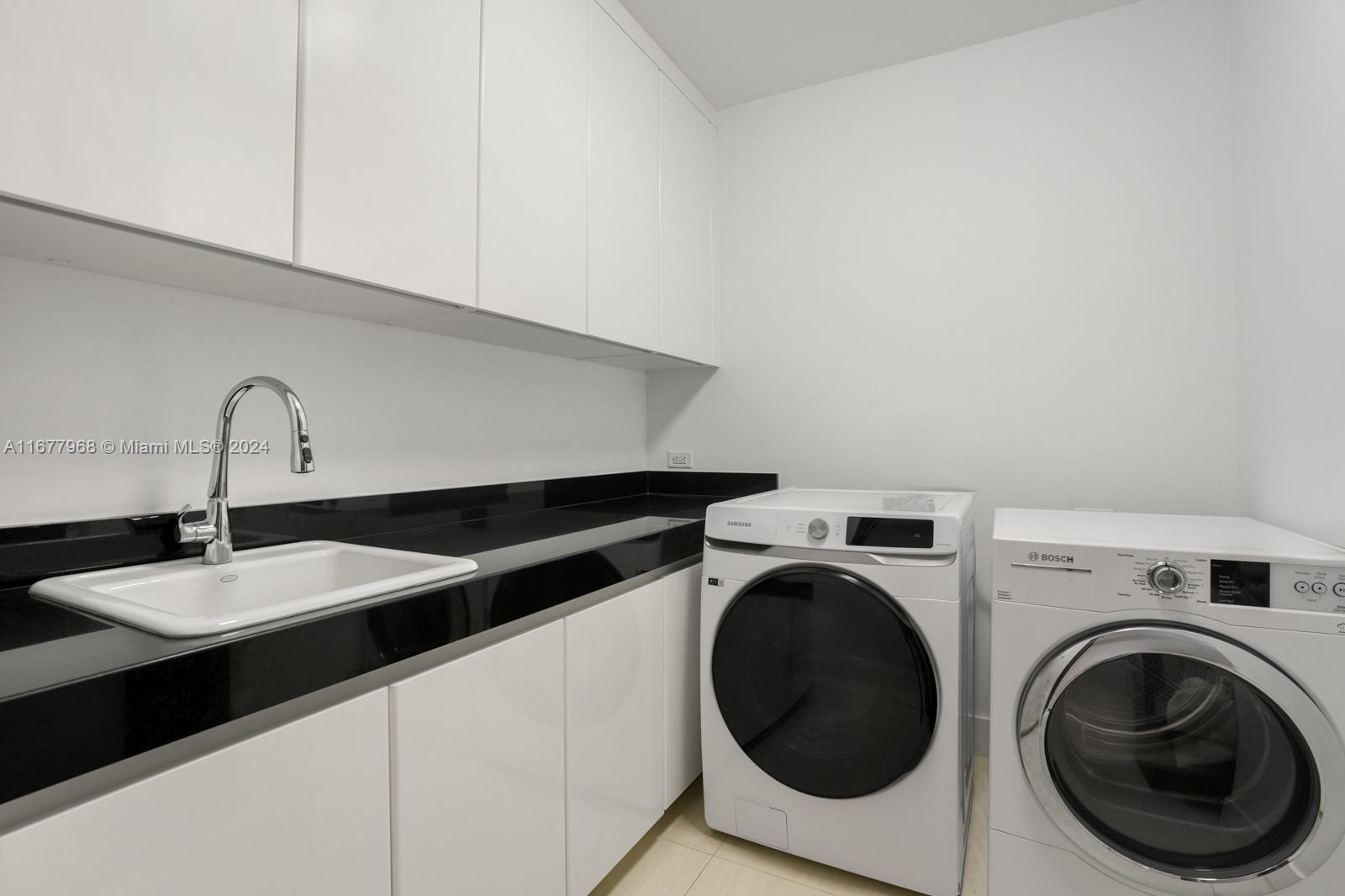 9705 Collins Avenue, Unit 501N Bal Harbour, FL 33154 - Photo 24 of 30 a close view of a sink and a washer dryer