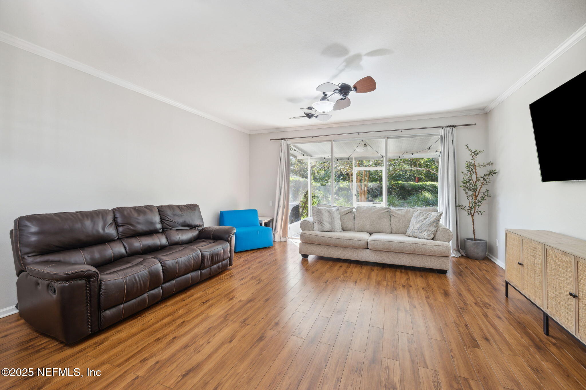 7990 Baymeadows Road East, Unit 2202 Jacksonville, FL 32256 - Photo 25 of 39 a living room with furniture and a flat screen tv