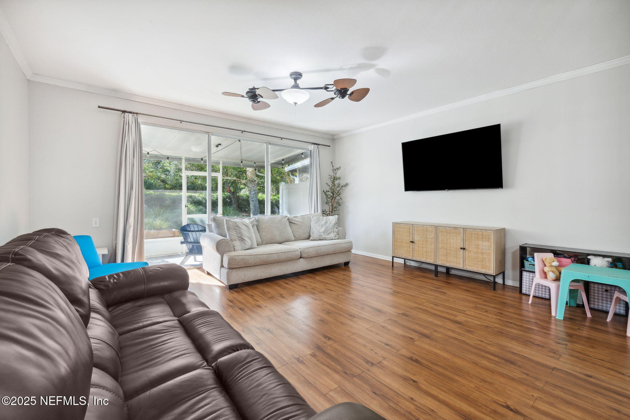 7990 Baymeadows Road East, Unit 2202 Jacksonville, FL 32256 - Photo 26 of 39 a living room with furniture and a flat screen tv