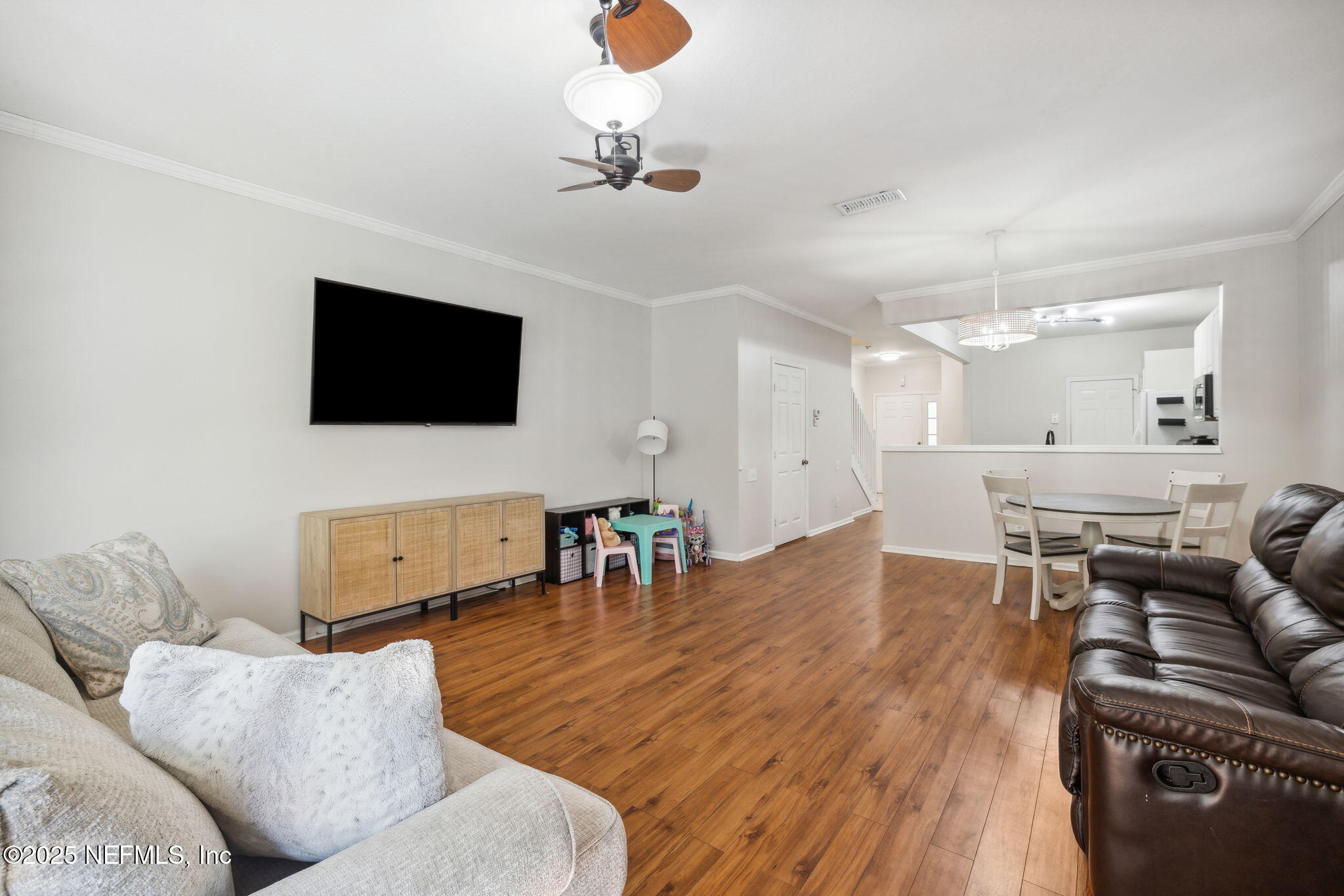 7990 Baymeadows Road East, Unit 2202 Jacksonville, FL 32256 - Photo 27 of 39 a living room with furniture and a flat screen tv