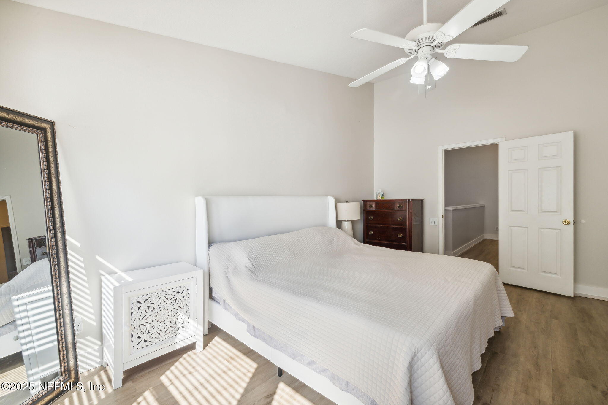 7990 Baymeadows Road East, Unit 2202 Jacksonville, FL 32256 - Photo 32 of 39 a bedroom with a large bed and a chandelier