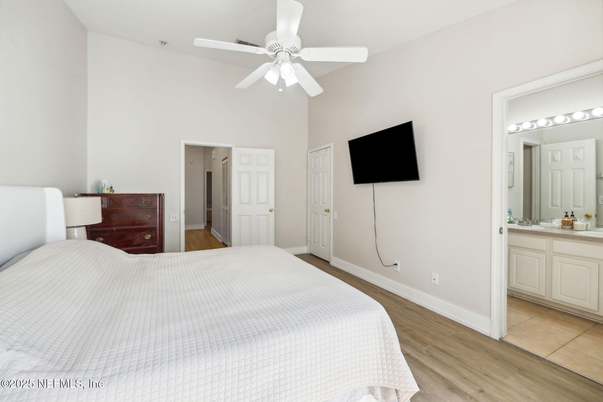 7990 Baymeadows Road East, Unit 2202 Jacksonville, FL 32256 - Photo 33 of 39 a bedroom with a bed and a flat screen tv