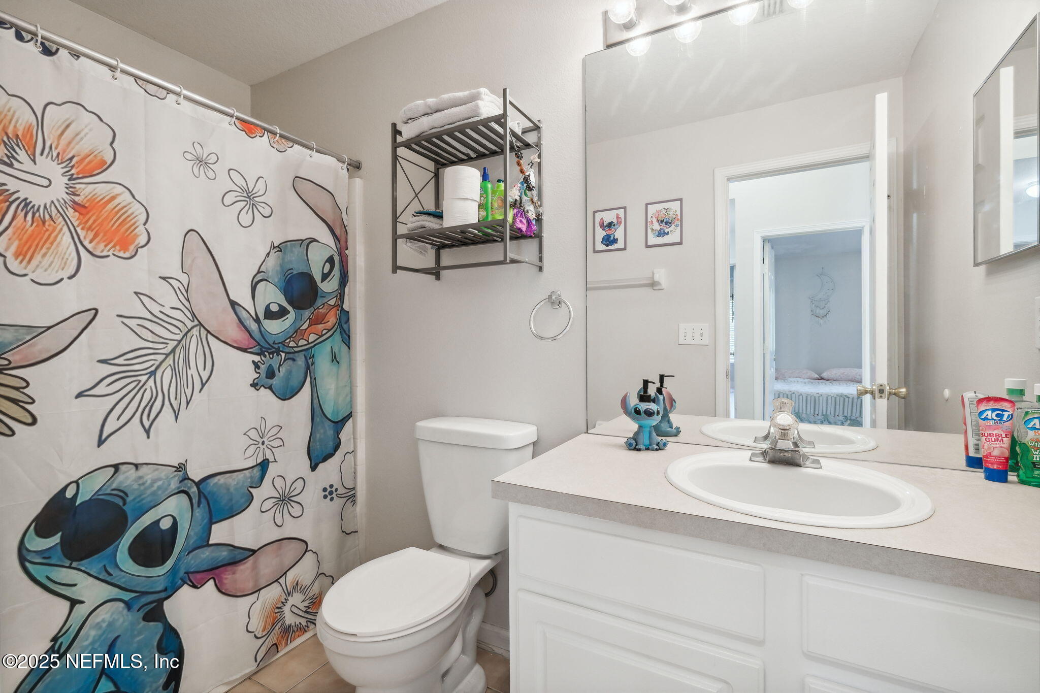 7990 Baymeadows Road East, Unit 2202 Jacksonville, FL 32256 - Photo 36 of 39 a bathroom with a toilet sink and mirror