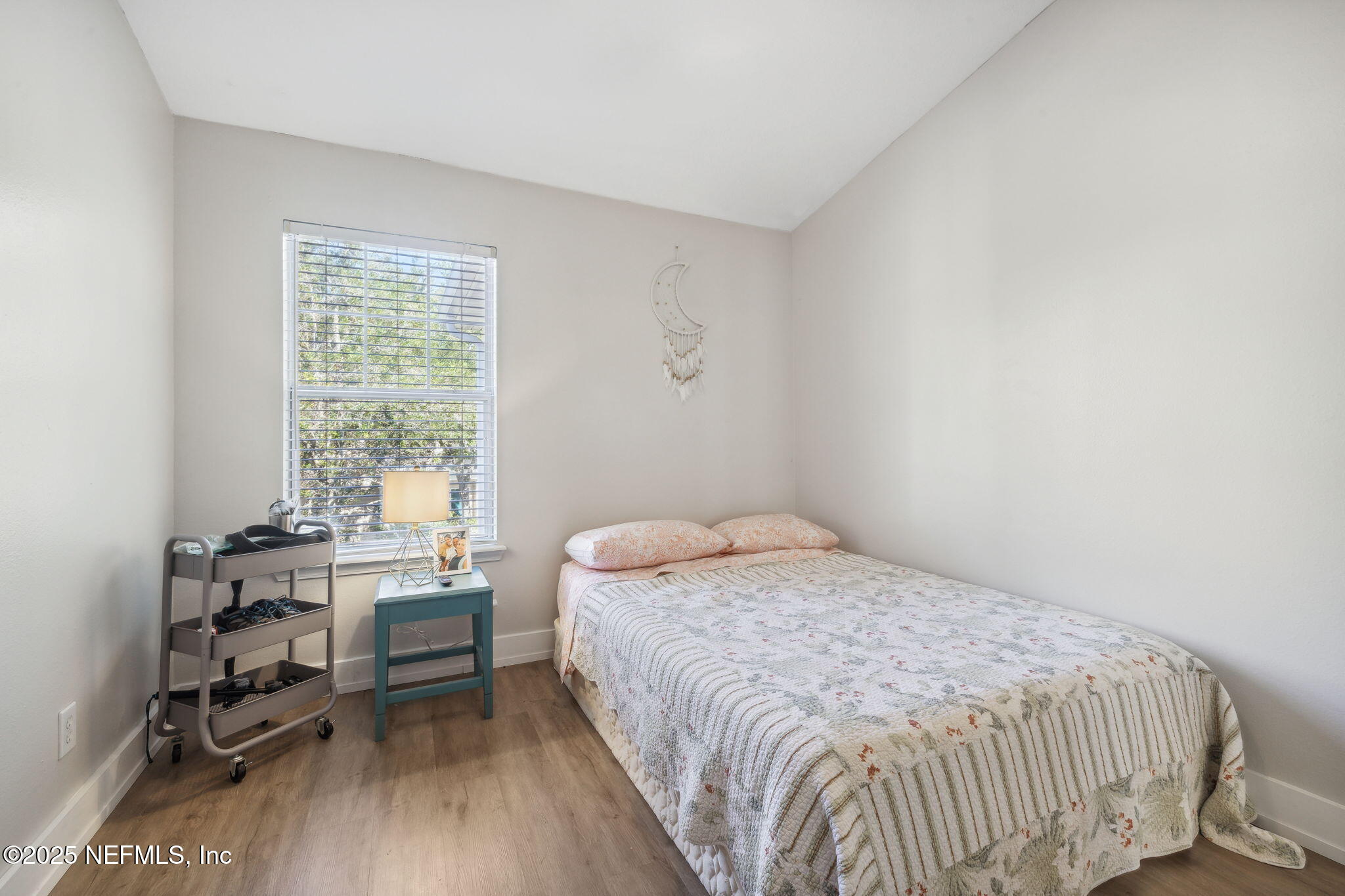 7990 Baymeadows Road East, Unit 2202 Jacksonville, FL 32256 - Photo 38 of 39 a bedroom with a bed and a table in it