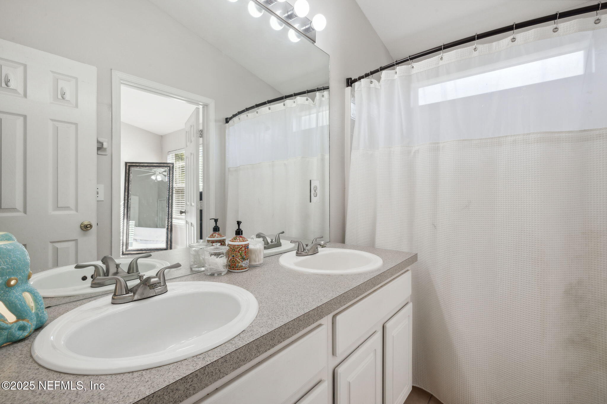 7990 Baymeadows Road East, Unit 2202 Jacksonville, FL 32256 - Photo 6 of 39 a bathroom with a double vanity sink and a mirror