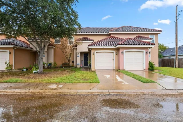 a front view of a house with a yard and garage