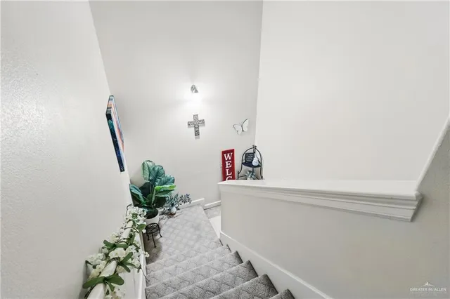 a hallway with table and a potted plants