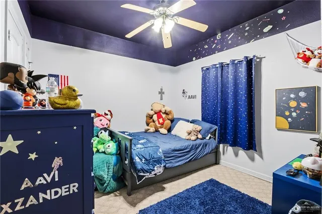 a living room with furniture and a baby crib