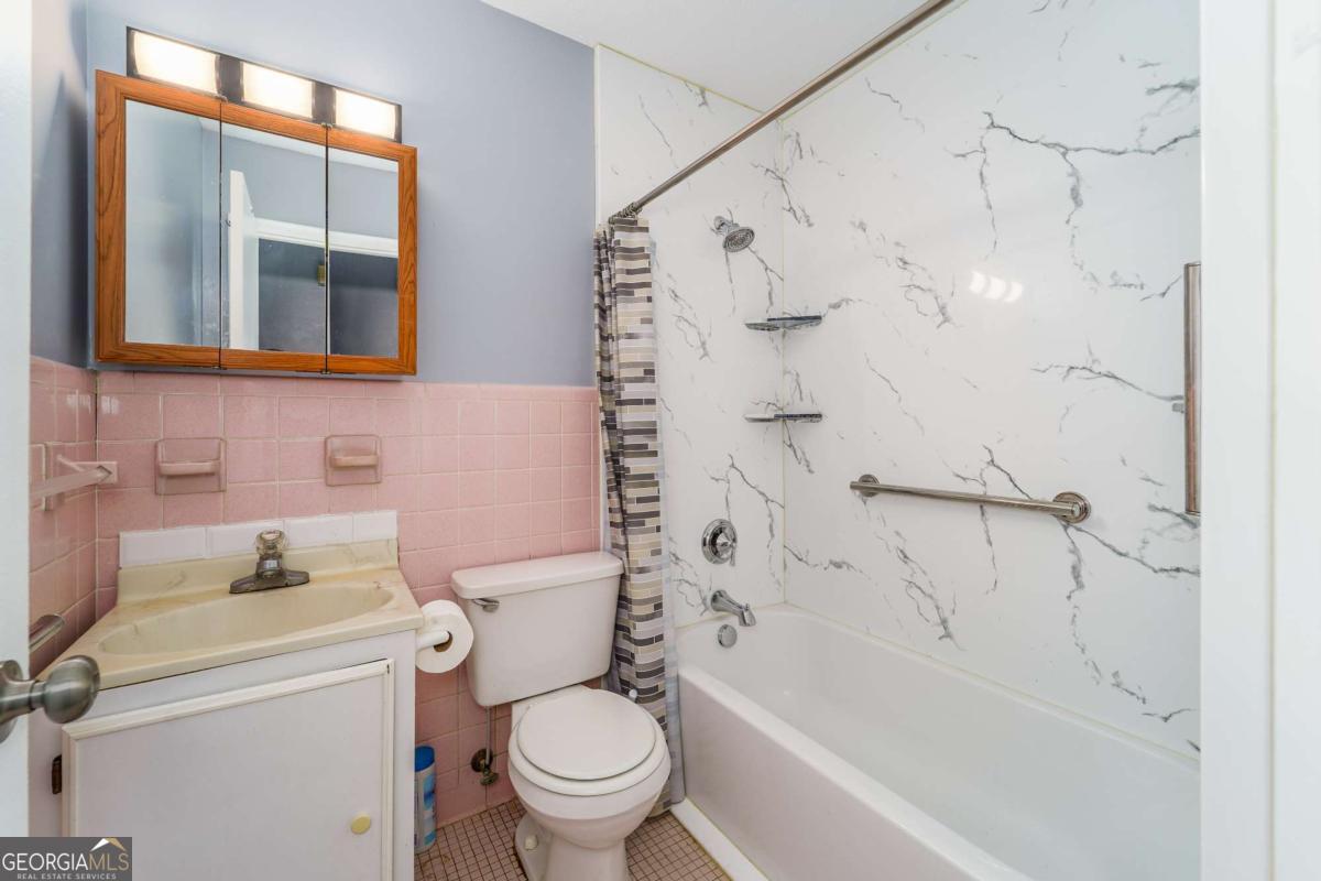 1703 Rainbow Drive Waycross, GA 31501 - Photo 15 of 19 a bathroom with a sink toilet and shower