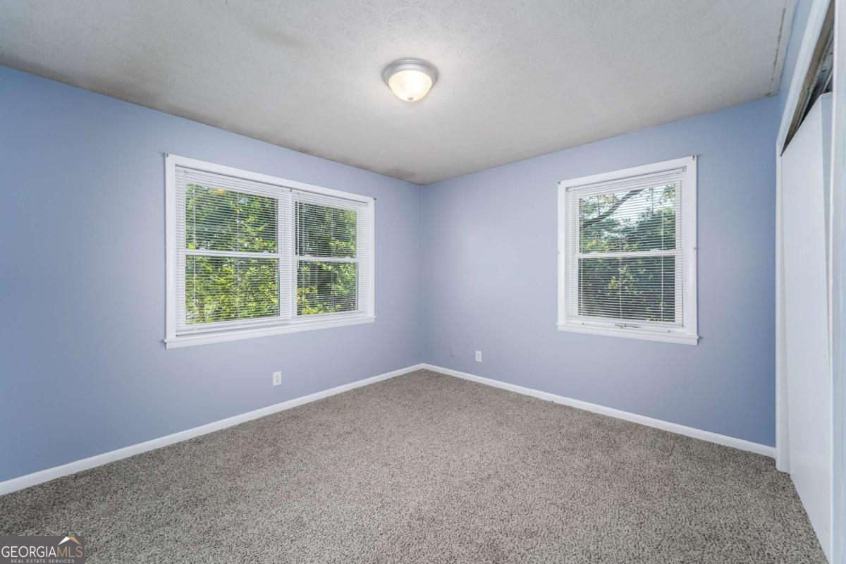1703 Rainbow Drive Waycross, GA 31501 - Photo 17 of 19 an empty room with windows