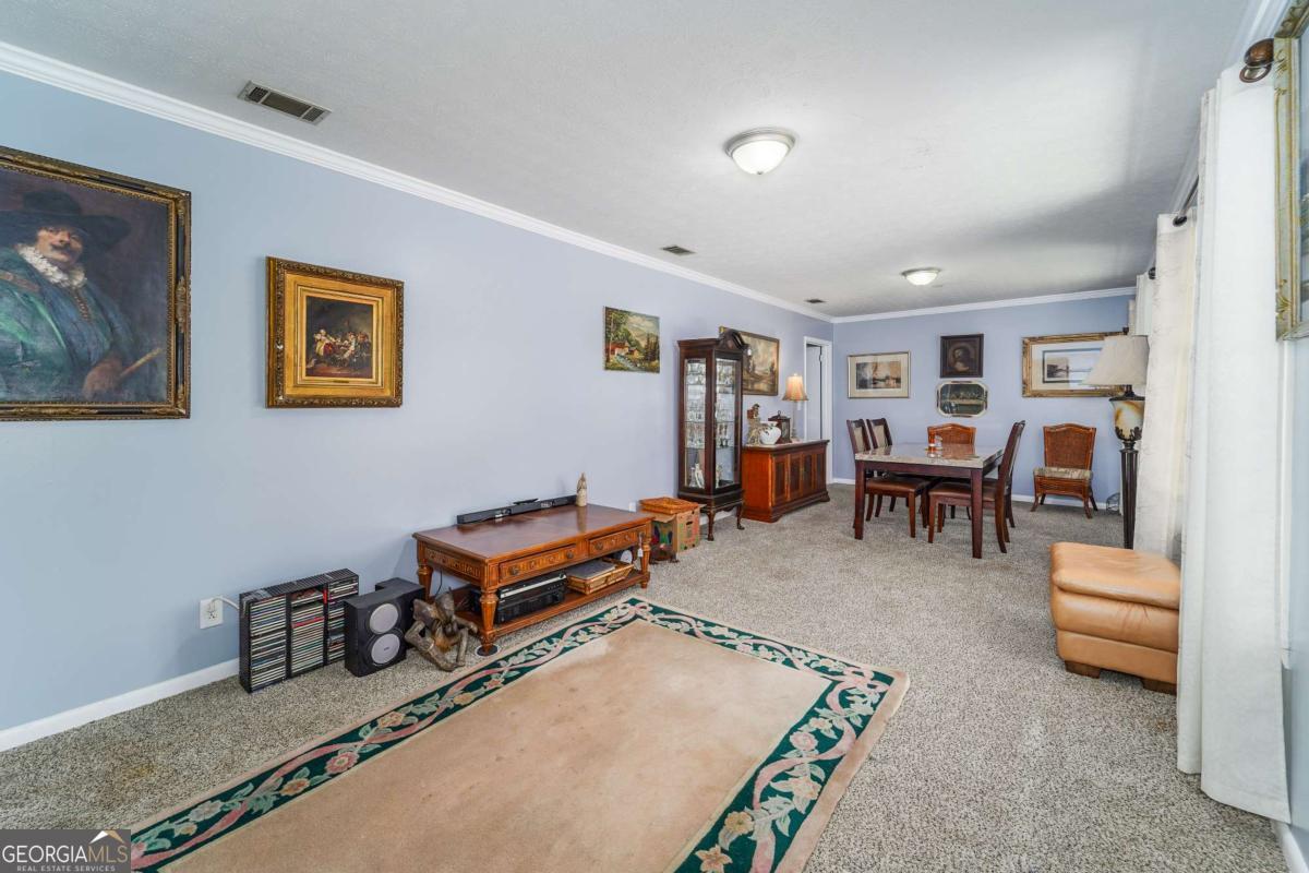 1703 Rainbow Drive Waycross, GA 31501 - Photo 5 of 19 a living room with furniture gym equipment and a table