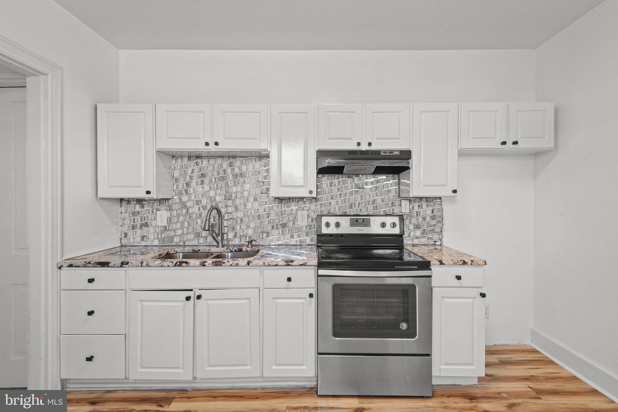 126 North Queen Street York, PA 17403 - Photo 11 of 33 a kitchen with stainless steel appliances granite countertop a stove and a white cabinets