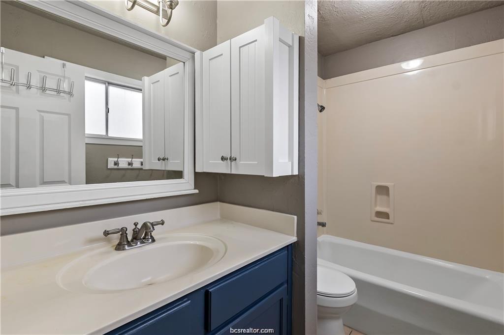 3906 Aspen Street, Unit B Bryan, TX 77801 - Photo 13 of 13 a bathroom with a sink a toilet and bathtub