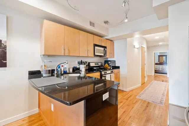 a kitchen with a sink a counter top space and appliances