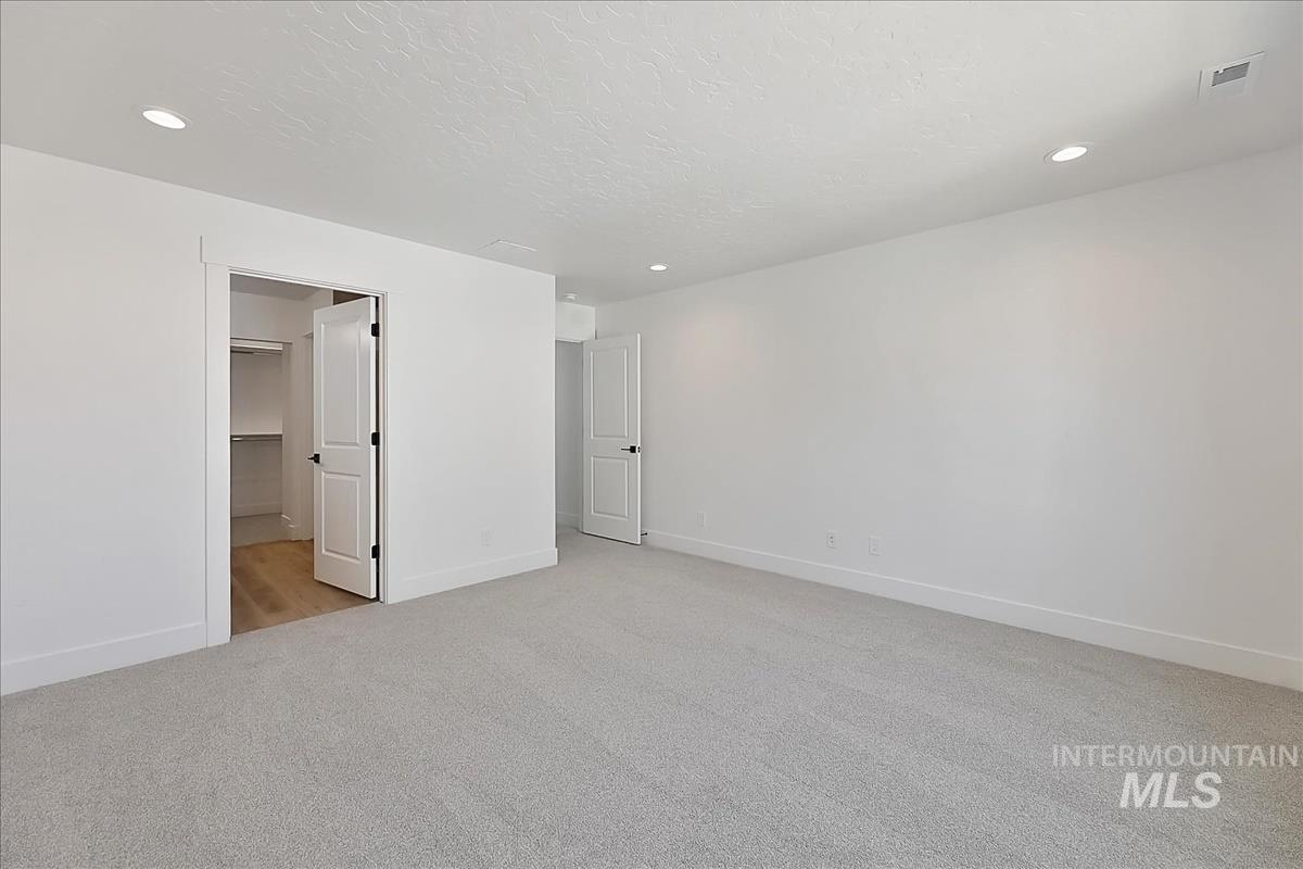 776 South Calhoun Lane Star, ID 83669 - Photo 26 of 49 Neutral-toned bedroom featuring recessed lighting, a light grey carpet, white walls, and a closet with wood-finish flooring
