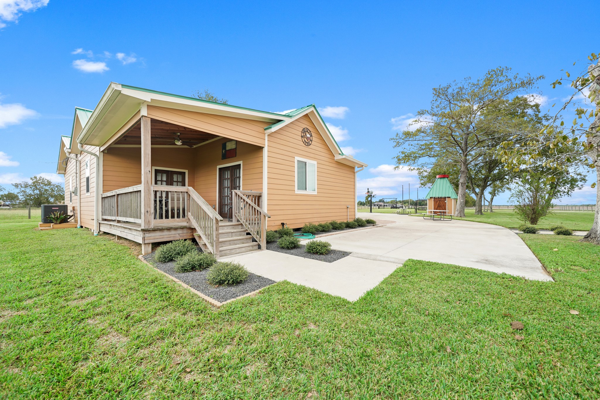 10507 Padon Road Needville, TX 77461 - Photo 19 of 48 a view of backyard of house with wooden fence and large trees