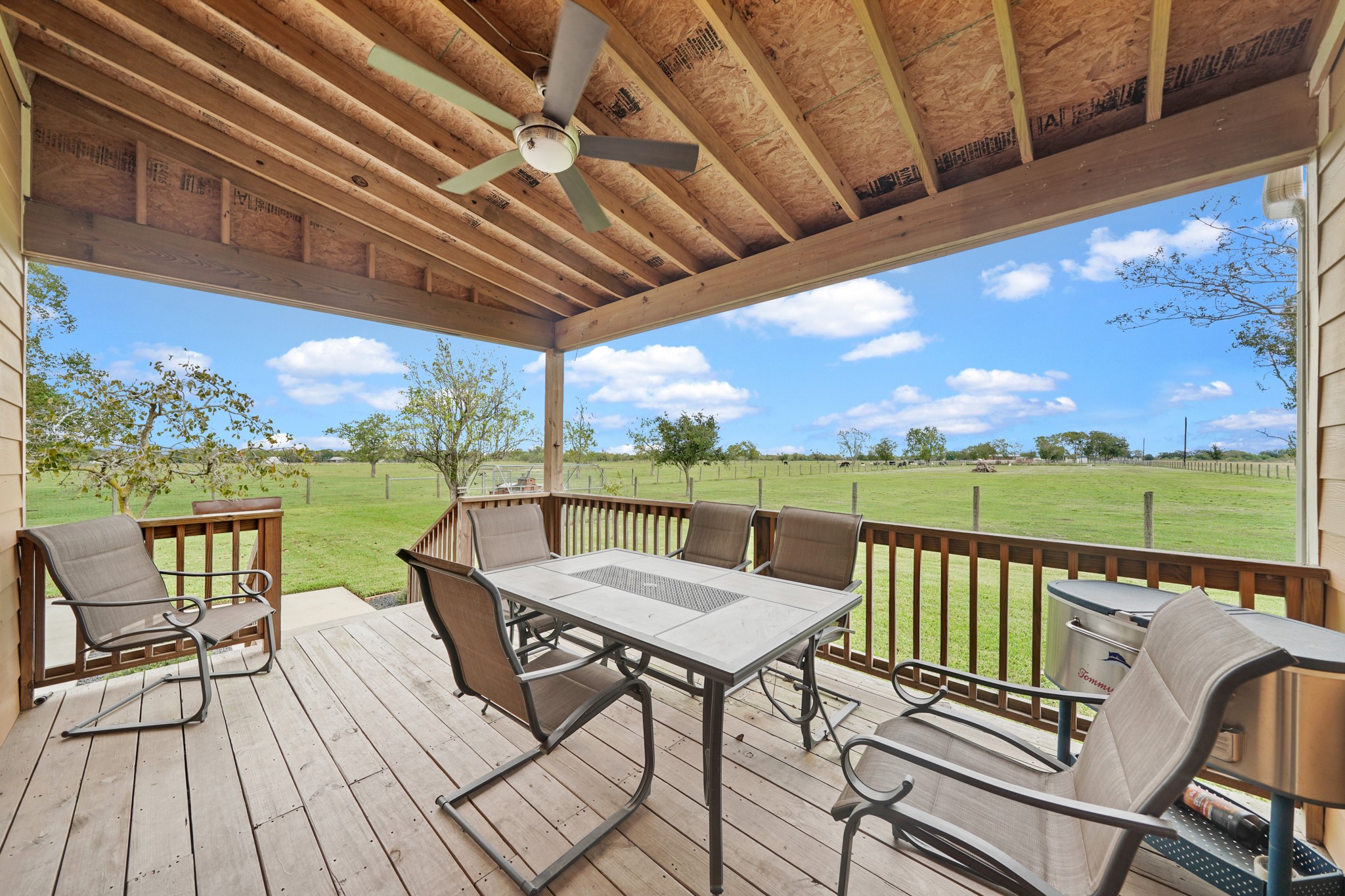 10507 Padon Road Needville, TX 77461 - Photo 20 of 48 a view of a balcony with wooden floor and outdoor seating