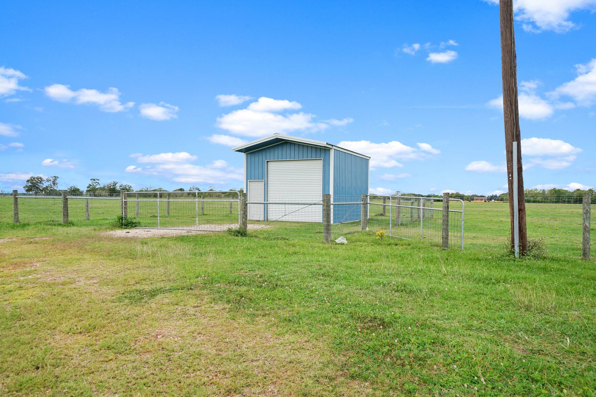 10507 Padon Road Needville, TX 77461 - Photo 21 of 48 a backyard of a house with lots of green space and garden