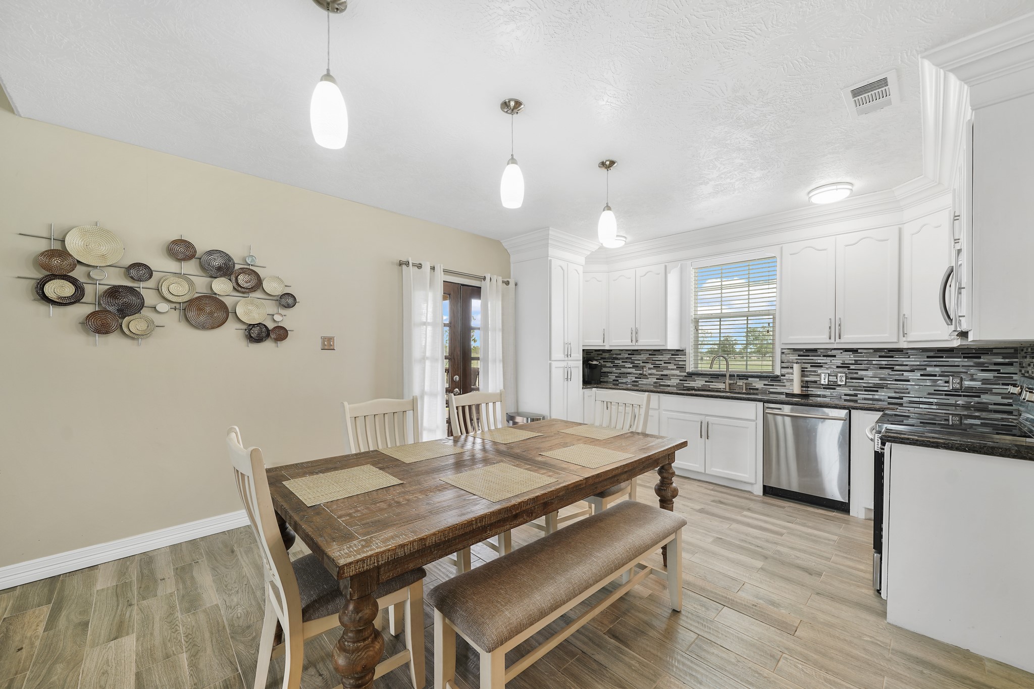 10507 Padon Road Needville, TX 77461 - Photo 29 of 48 a kitchen with a table chairs stove and microwave