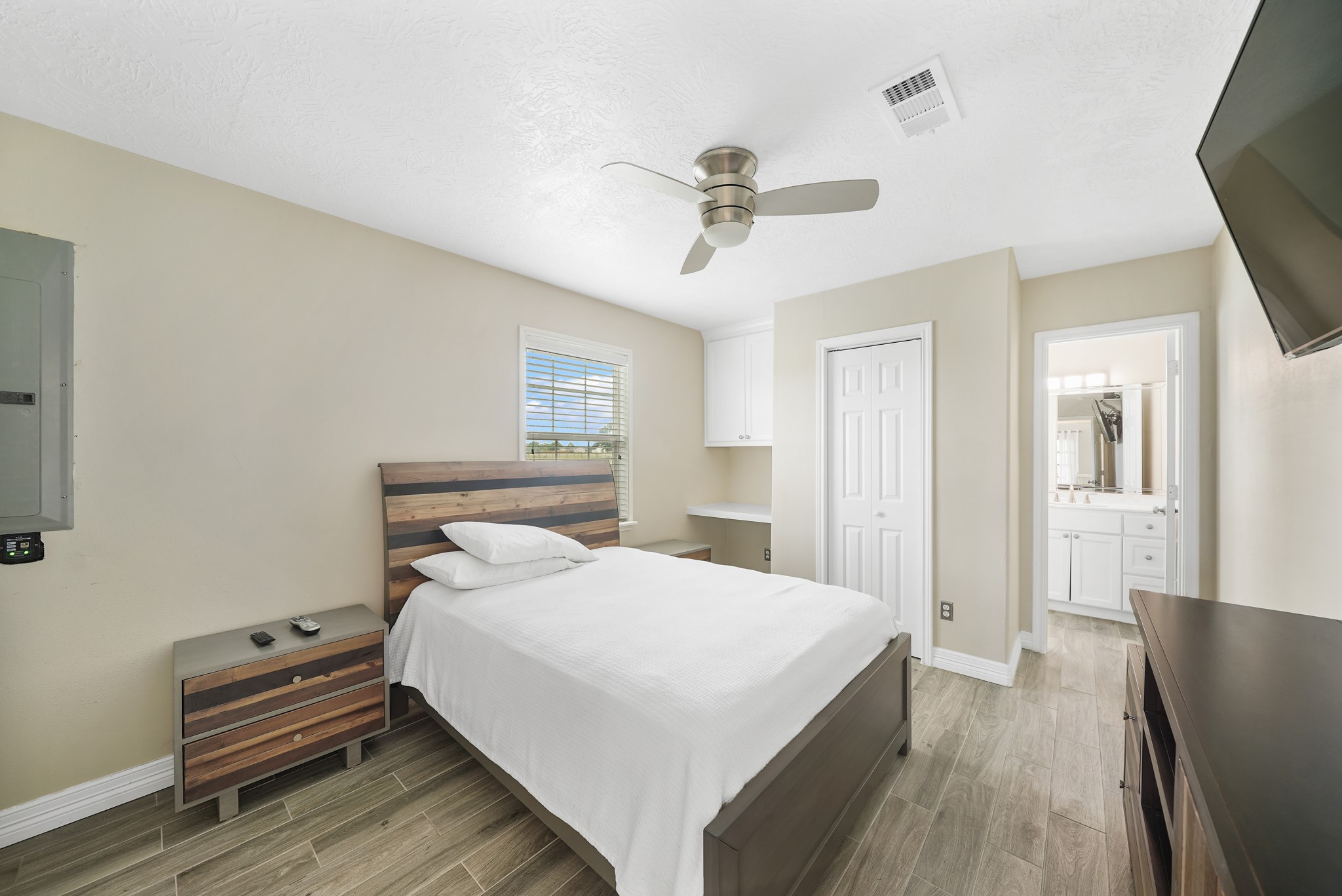 10507 Padon Road Needville, TX 77461 - Photo 34 of 48 a bedroom with a bed and a chandelier