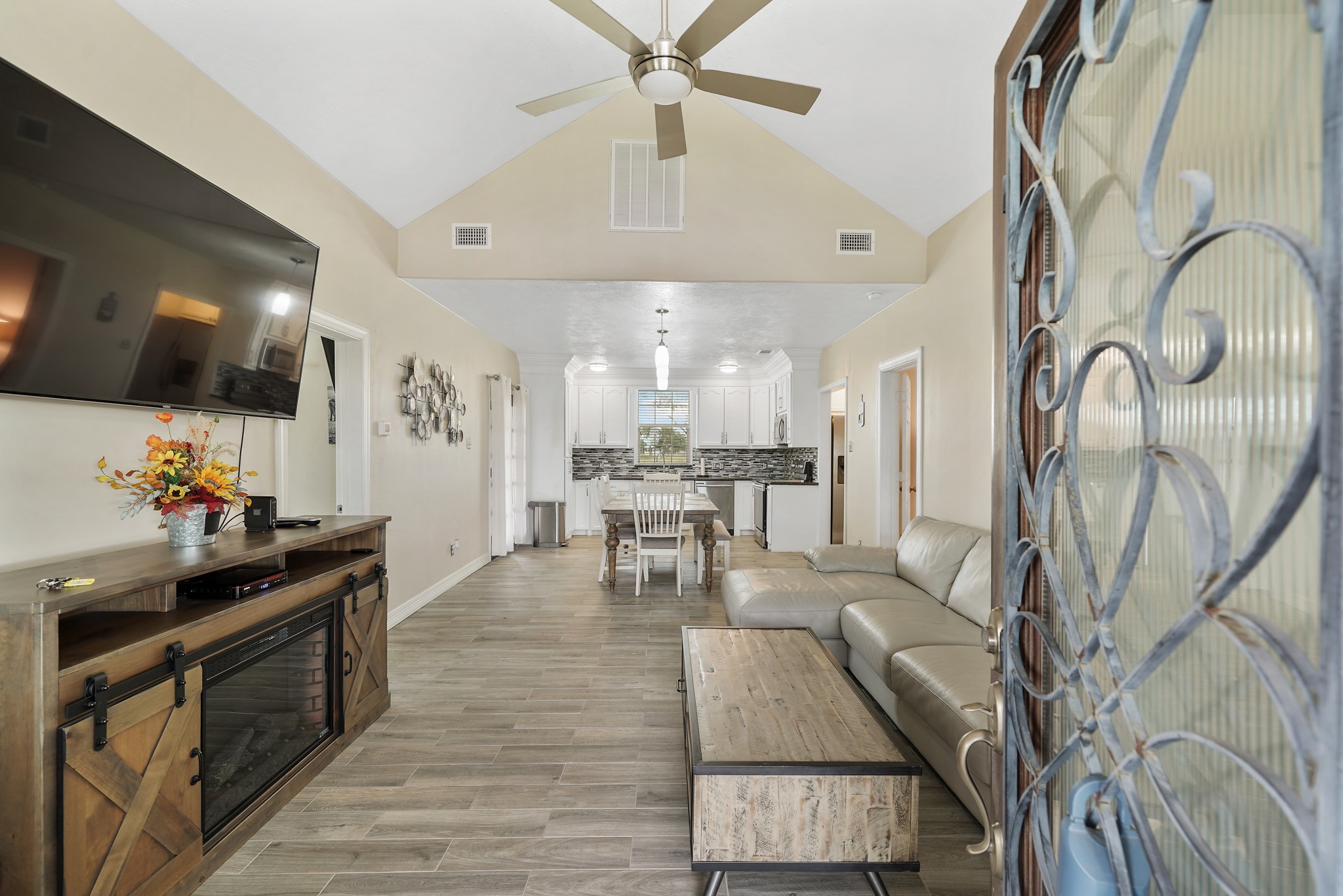 10507 Padon Road Needville, TX 77461 - Photo 42 of 48 a kitchen with stainless steel appliances kitchen island granite countertop a table chairs in it and wooden floors