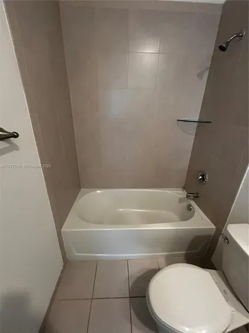 a bathroom with a toilet and a bath tub