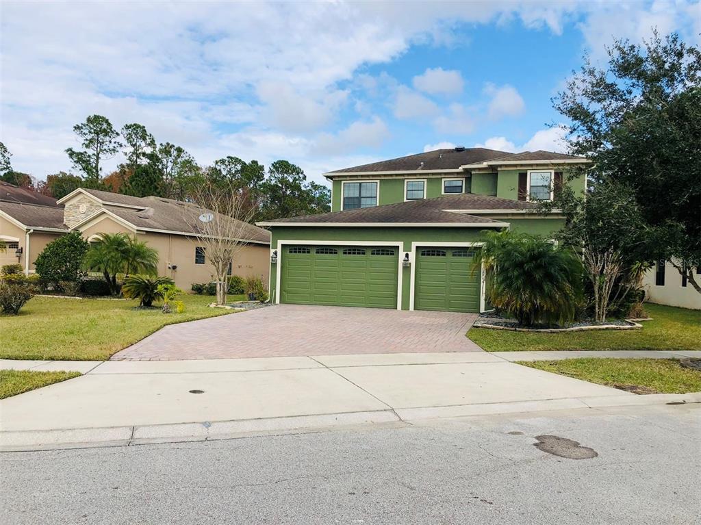 10802 Willow Ridge Loop Orlando, FL 32825 - Photo 1 of 1 a front view of house with yard and green space