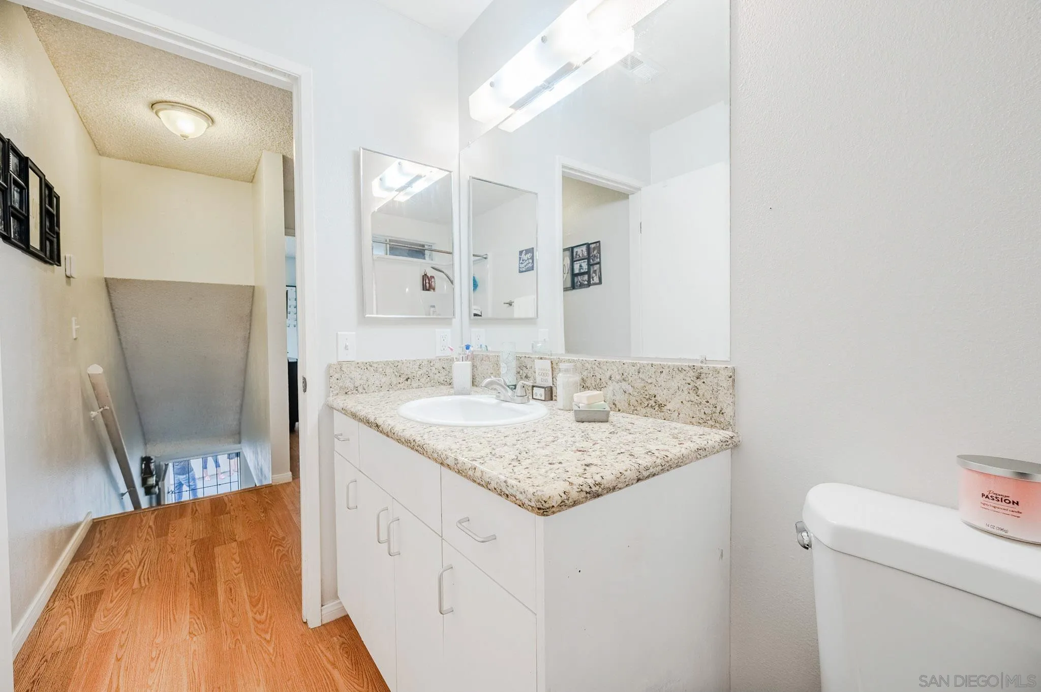 5140 North River Road, Unit F Oceanside, CA 92057 - Photo 28 of 39 a bathroom with a granite countertop sink and a mirror