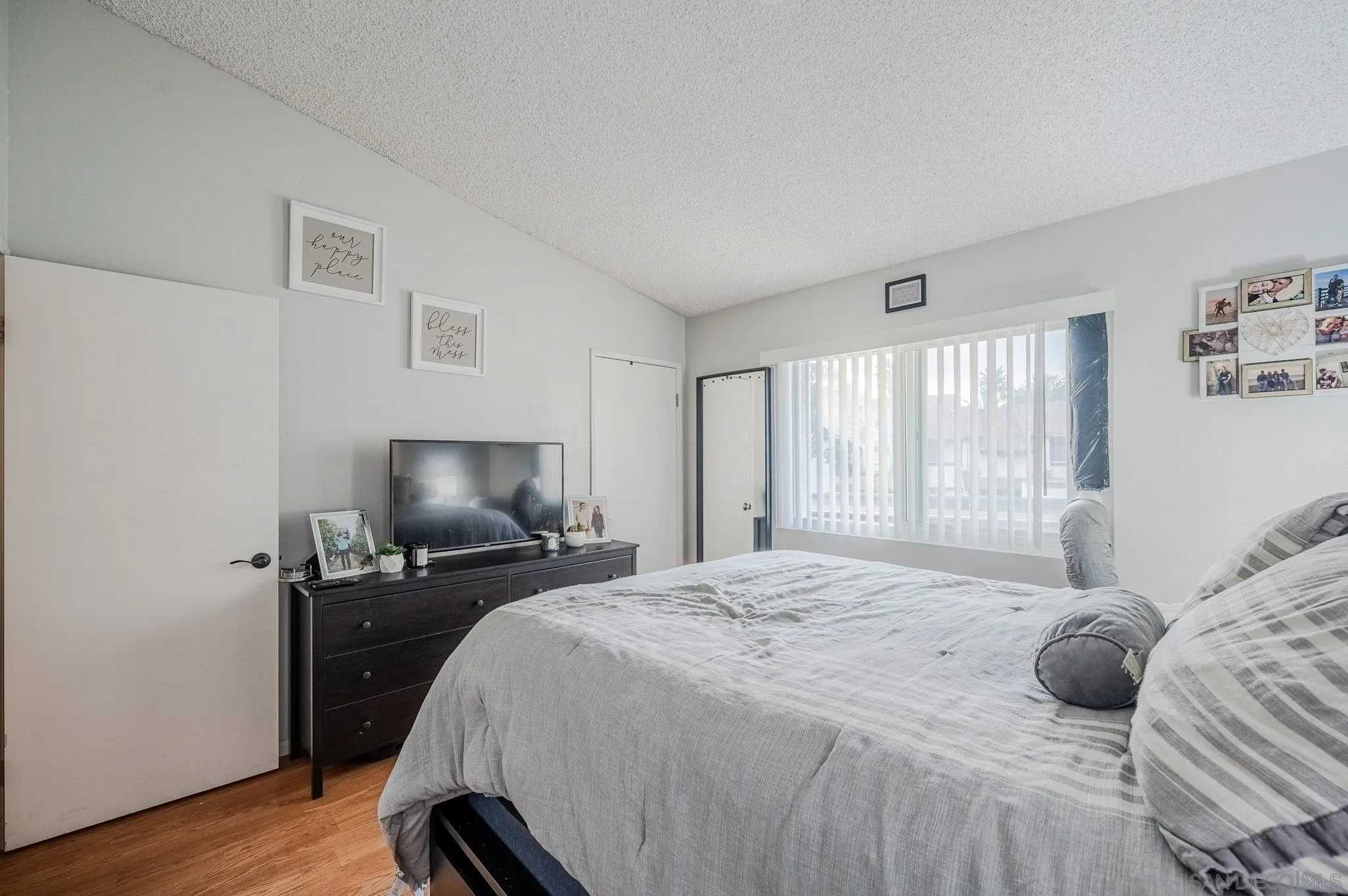 5140 North River Road, Unit F Oceanside, CA 92057 - Photo 33 of 39 a bedroom with a bed and wooden floor